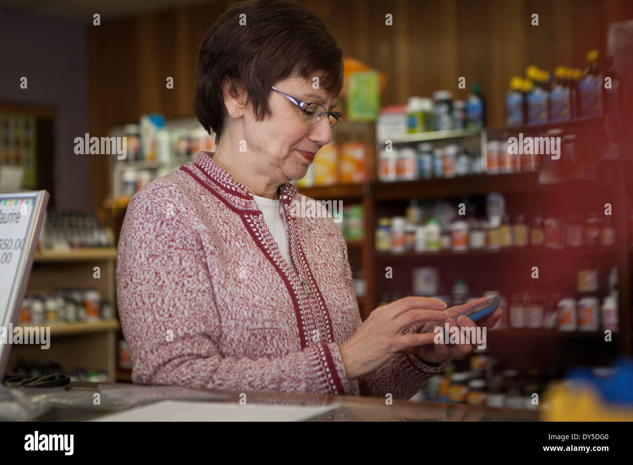 Owner of health foods store using smartphone Stock Photo