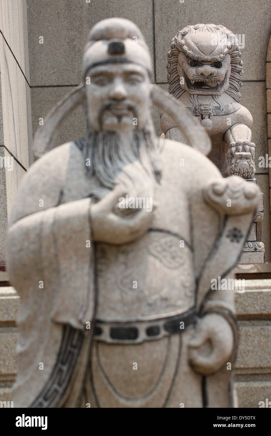Statues of Chinese deity in focus lion sculpture of chinese temple. Stock Photo