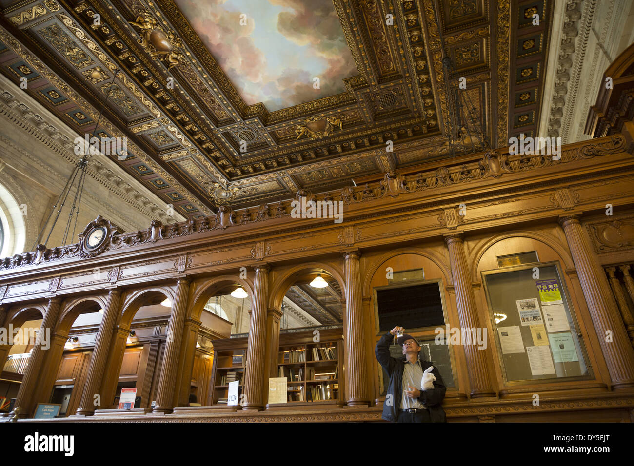 Man photographing the elaborate ceiling of the Rose Reading Room in the New York Public Library Stock Photo