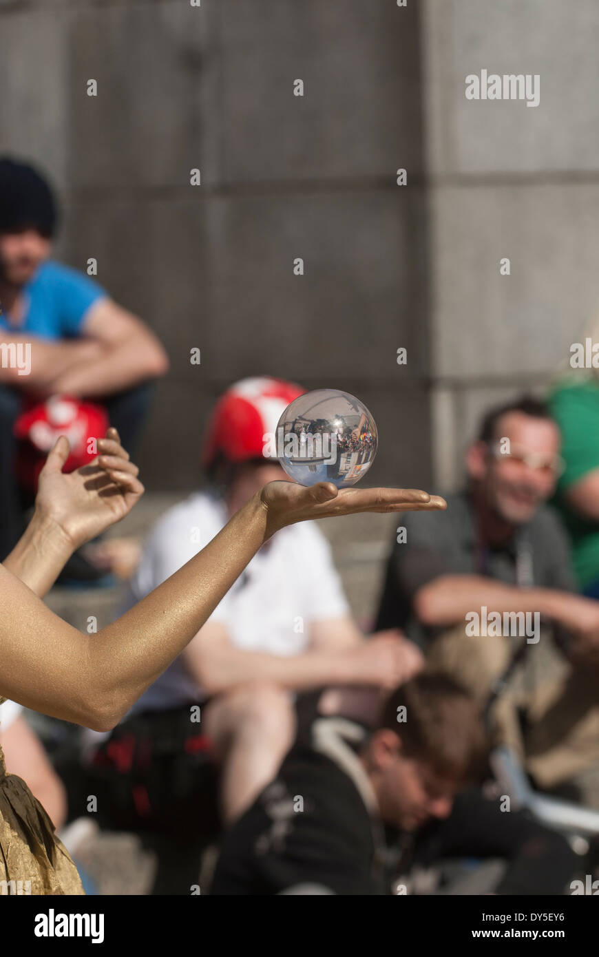 Gold painted woman holding a crystal ball Stock Photo - Alamy