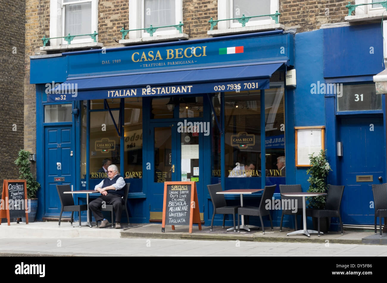 Man sitting outside the Casa Becci Italian restaurant In Paddington Street, London. Stock Photo
