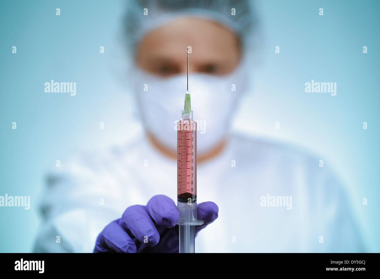 Doctor holding syringe Stock Photo