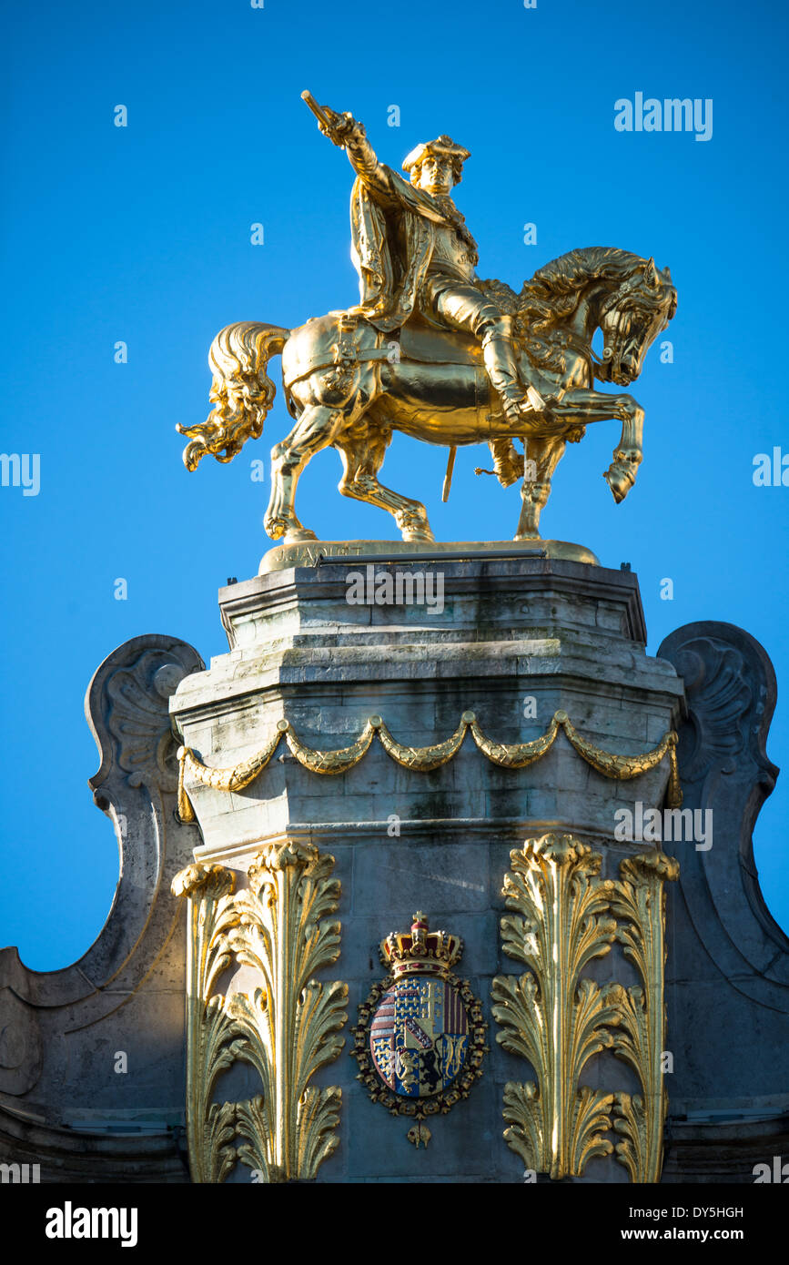 A gold equestrian statue sits astride one of the ornate buildings on Grand Place (La Grand-Place), a UNESCO World Heritage Site in central Brussels, Belgium. Lined with ornate, historic buildings, the cobblestone square is the primary tourist attraction in Brussels. Stock Photo