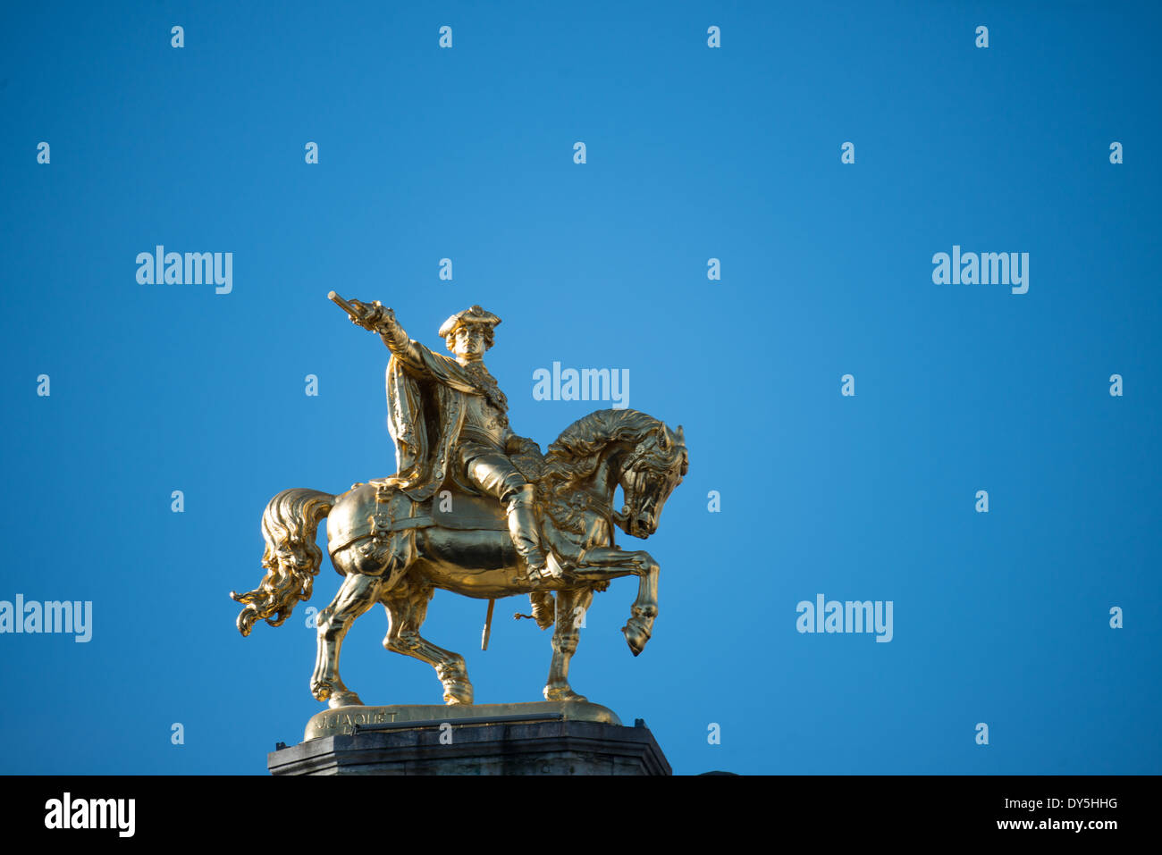 A gold equestrian statue sits astride one of the ornate buildings on Grand Place (La Grand-Place), a UNESCO World Heritage Site in central Brussels, Belgium. Lined with ornate, historic buildings, the cobblestone square is the primary tourist attraction in Brussels. Stock Photo