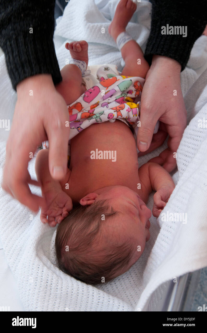 Newborn baby girl being dressed for the first time by her father Stock ...
