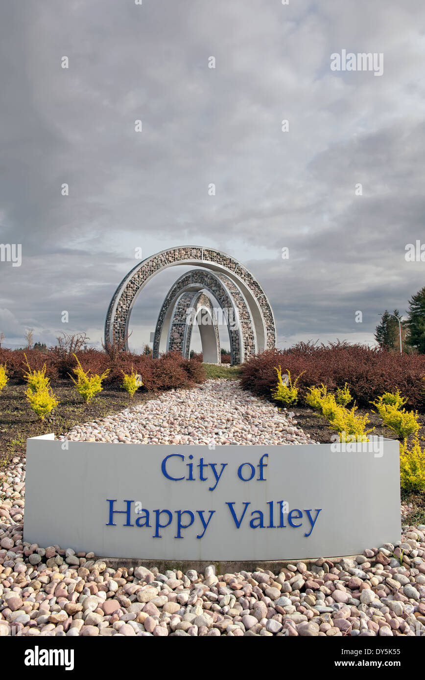 City of Happy Valley Oregon Entry Sign with Landscaping and Stormy Sky Stock Photo