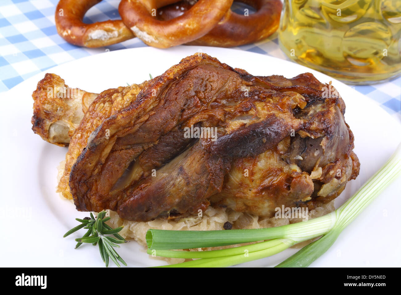 Grilled pork hock with sauerkraut, pretzels, beer, close up Stock Photo
