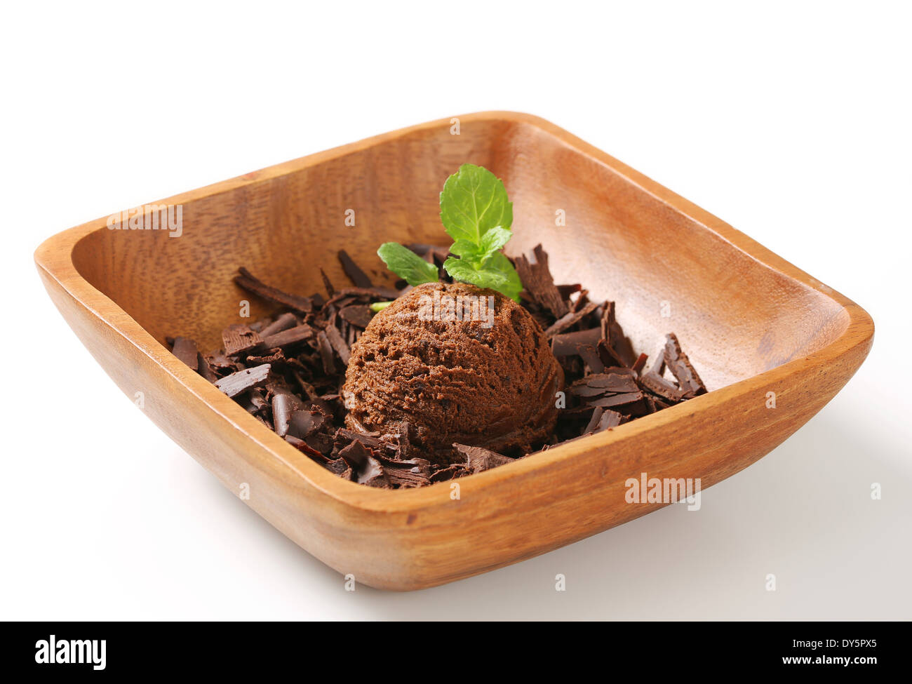 Scoop of ice cream and chocolate shavings in wooden bowl Stock Photo