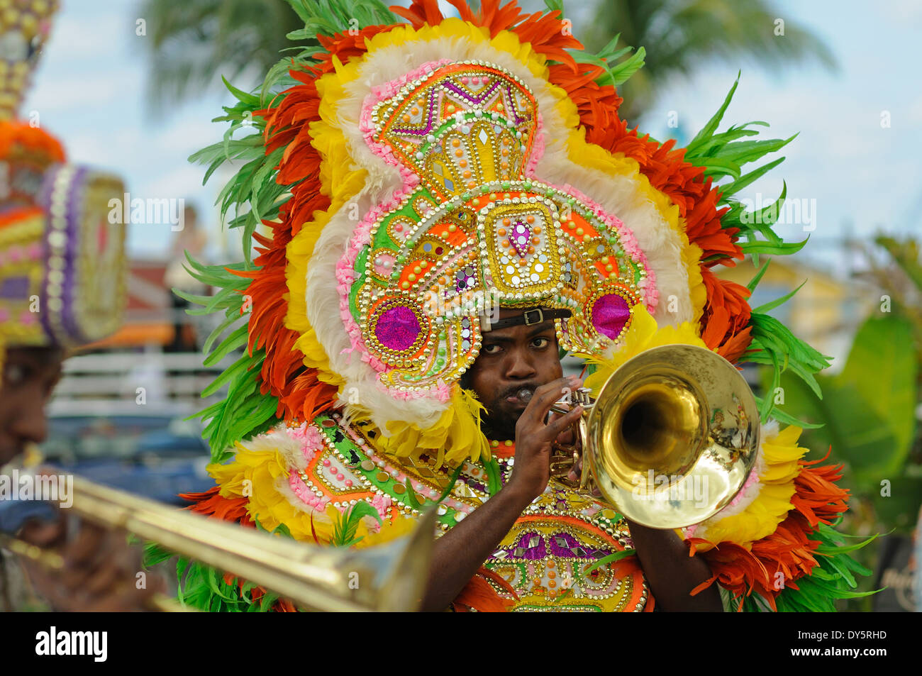 trumpeter in carnival dress in a Junkanoo band playing in a street parade on Nassau Bahamas Stock Photo