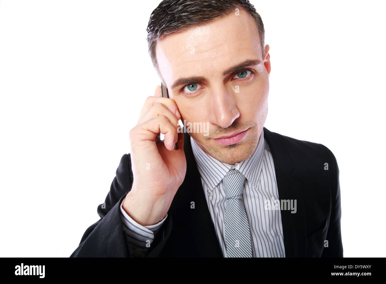 Business man talking on his mobile phone over white background Stock Photo
