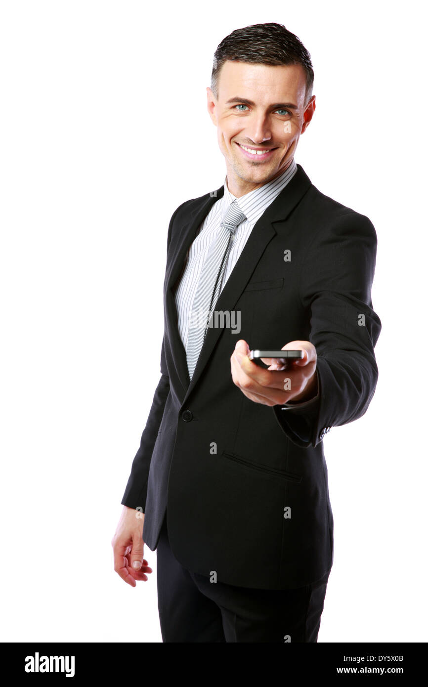 Smiling businessman in a suit giving you a smartphone over white ...