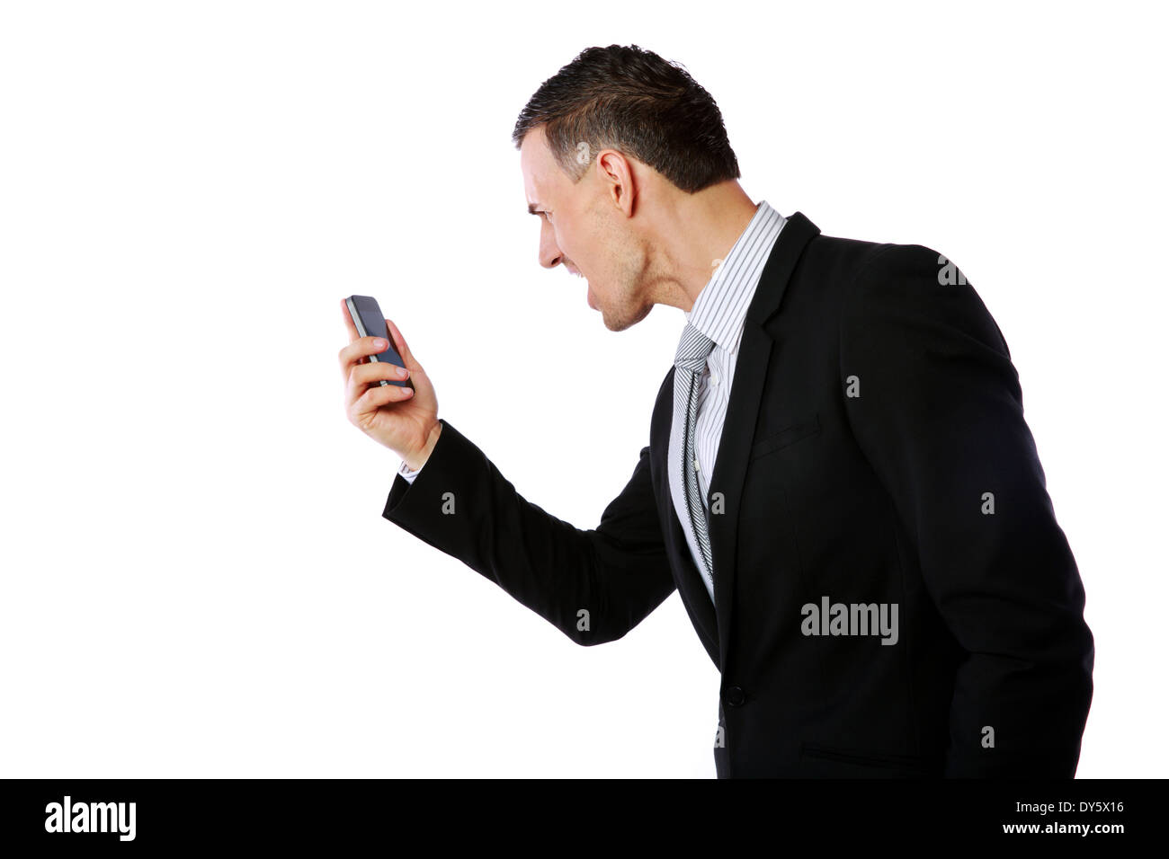 Angry businessman yelling on his cell phone over white background Stock Photo