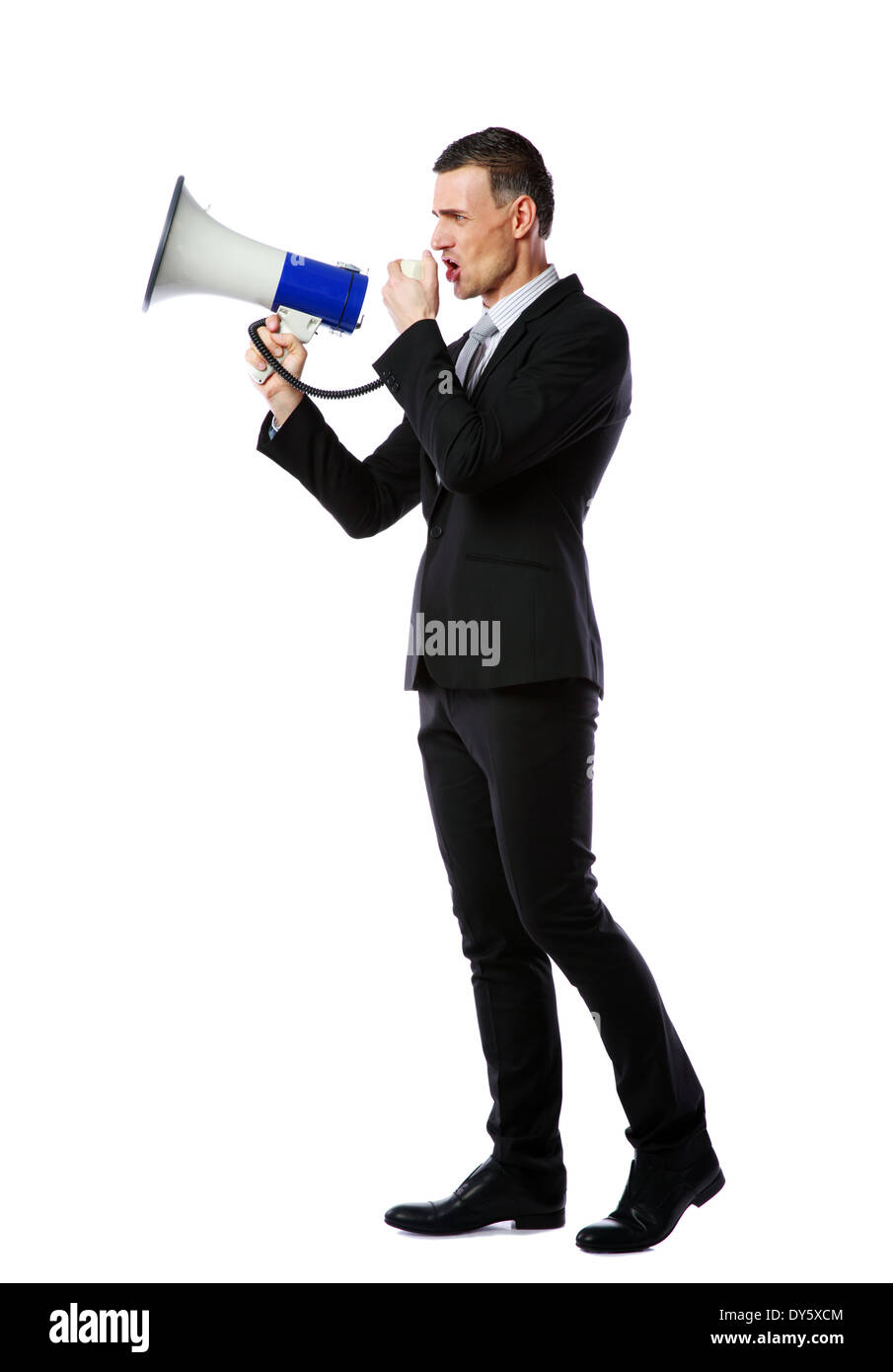 Full length portrait of businessman yelling through megaphone isolated on white background Stock