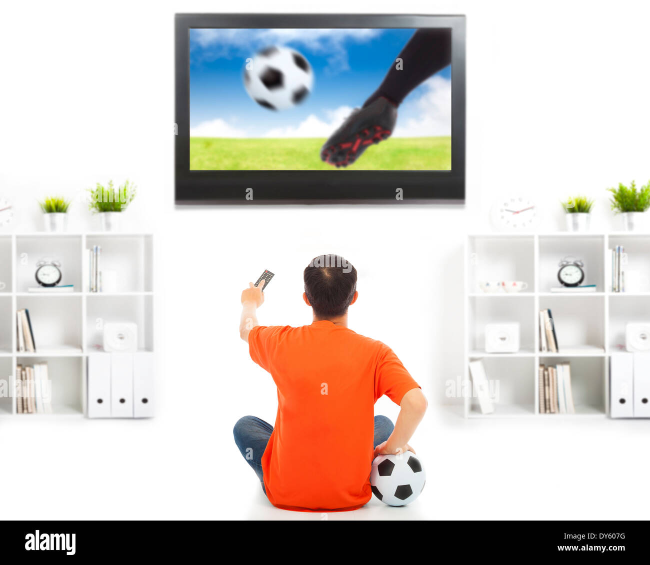 young fan watching soccer game at home Stock Photo