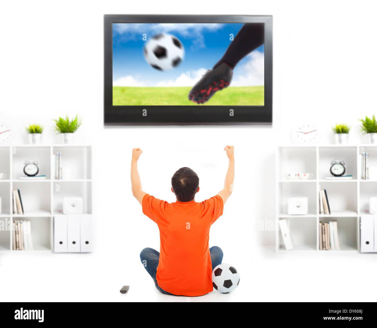 happy fan watching soccer game and raised hands Stock Photo