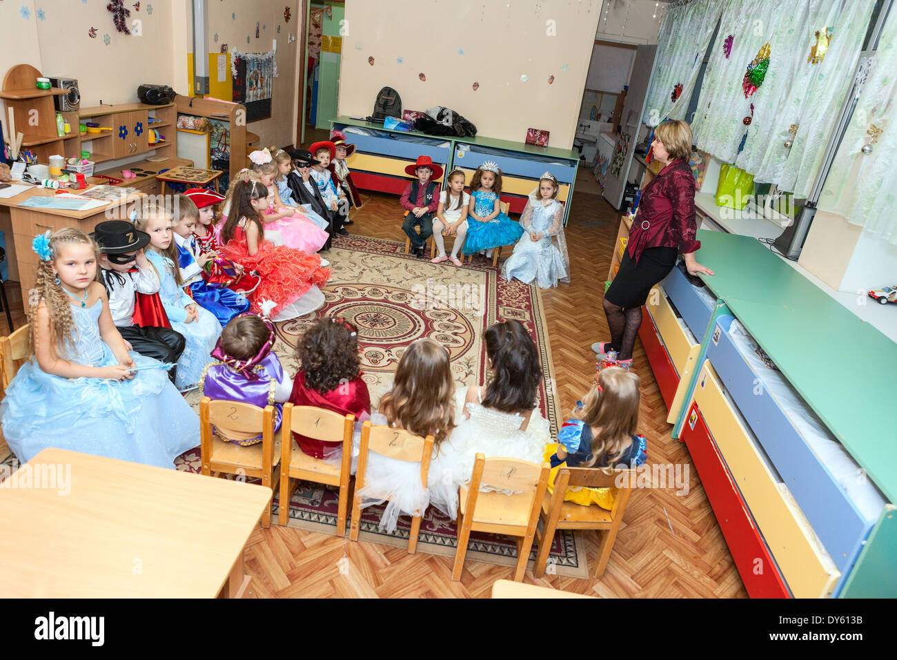 Teacher is in kindergarten or daycare center, Russia. Graduation party is in daycare center Stock Photo