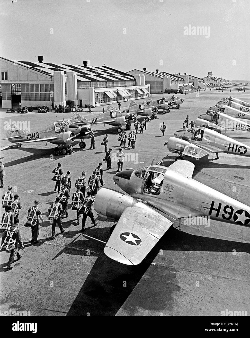 [Pilots Walking Towards Aircraft Hangar, Pepperell Manufacturing Company] Stock Photo