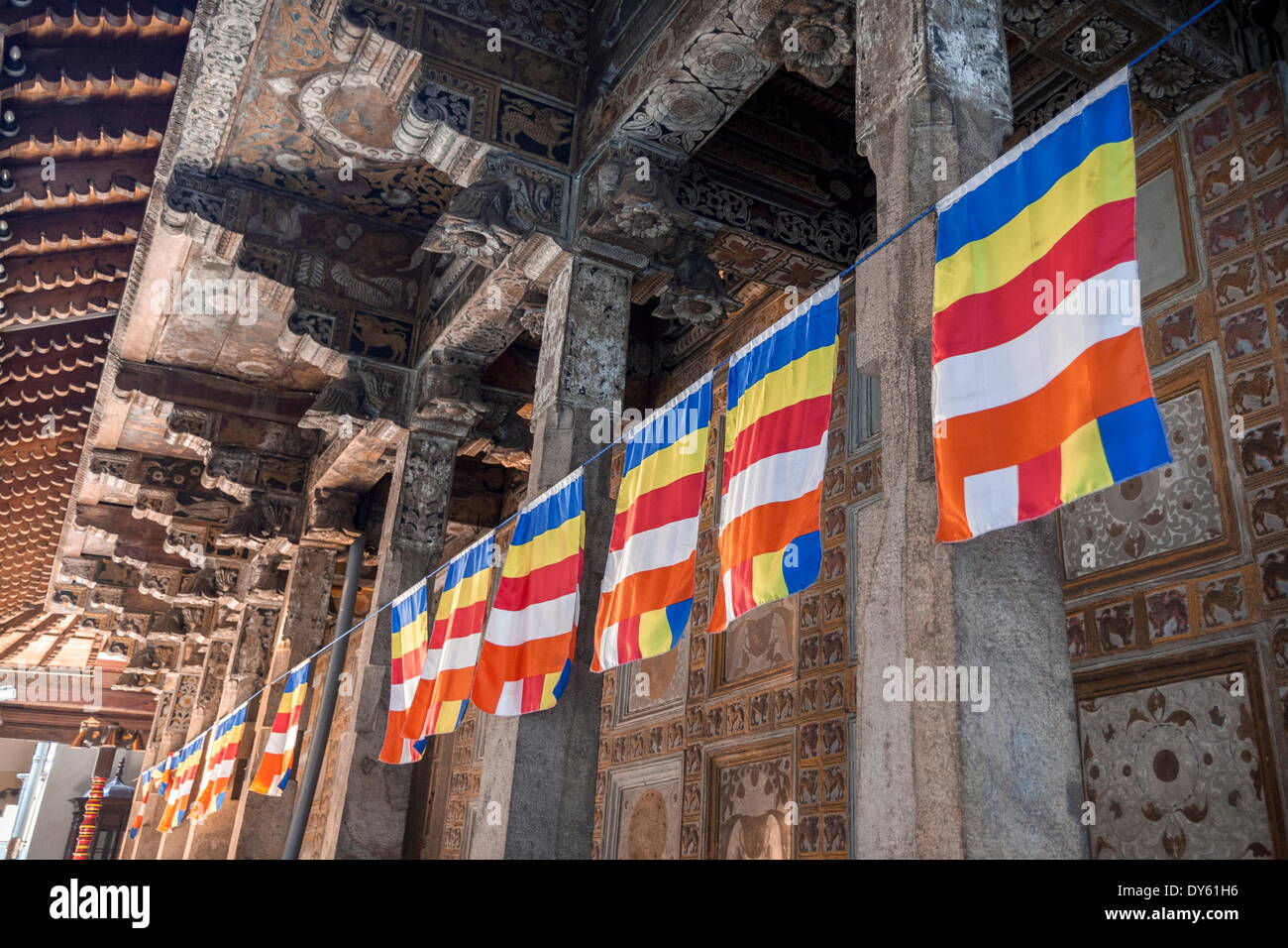 Colourful Buddhist flags adorning columns, Temple of the Sacred Tooth Relic, UNESCO World Heritage Site, Kandy, Sri Lanka, Asia Stock Photo