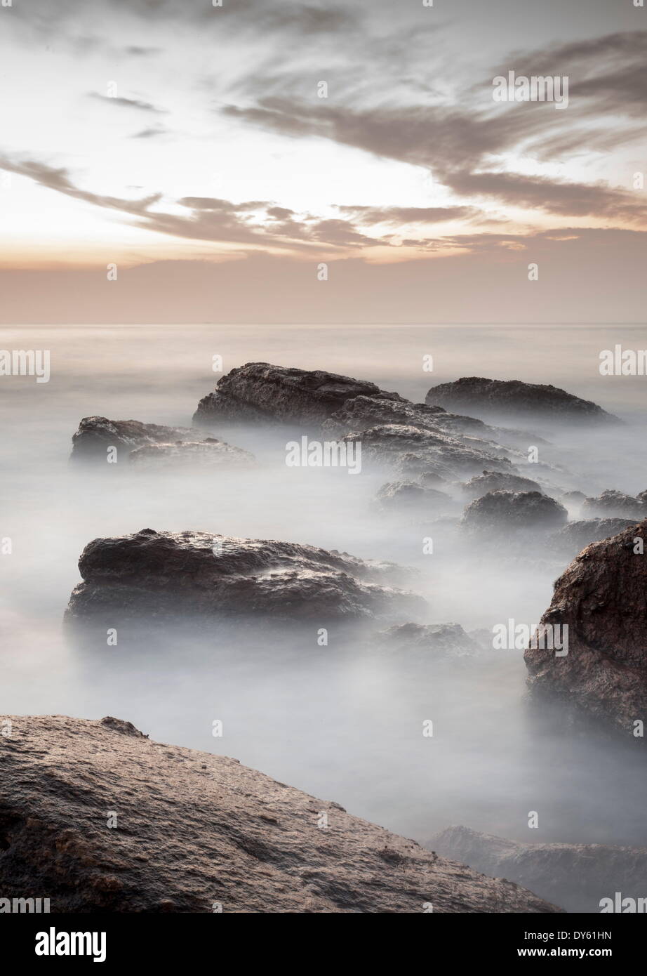 Sunrise over ocean and rocks hi-res stock photography and images - Alamy
