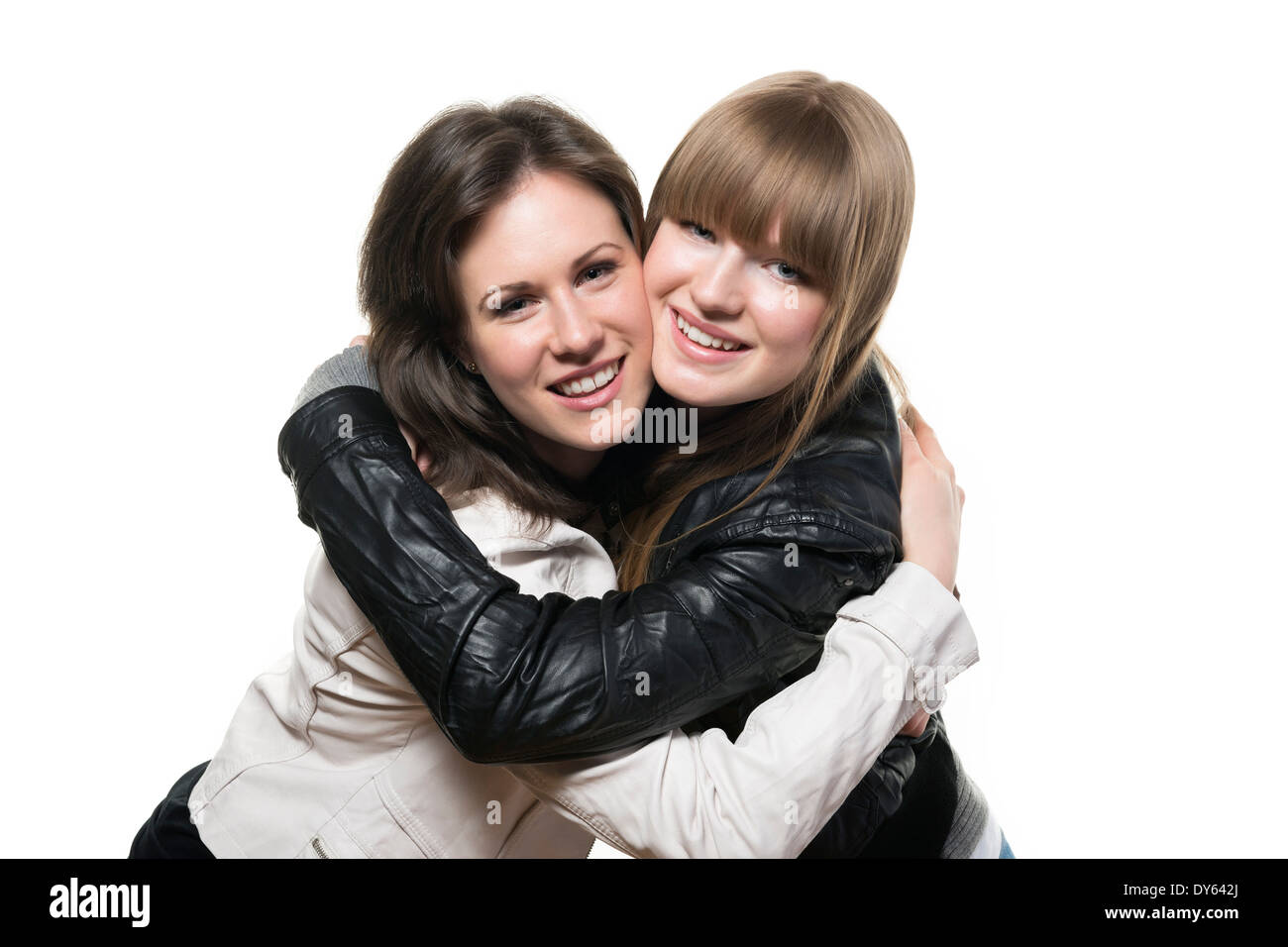 Portrait of two happy woman, blond and brunette, with black and white leather jacket, isolated on white background Stock Photo