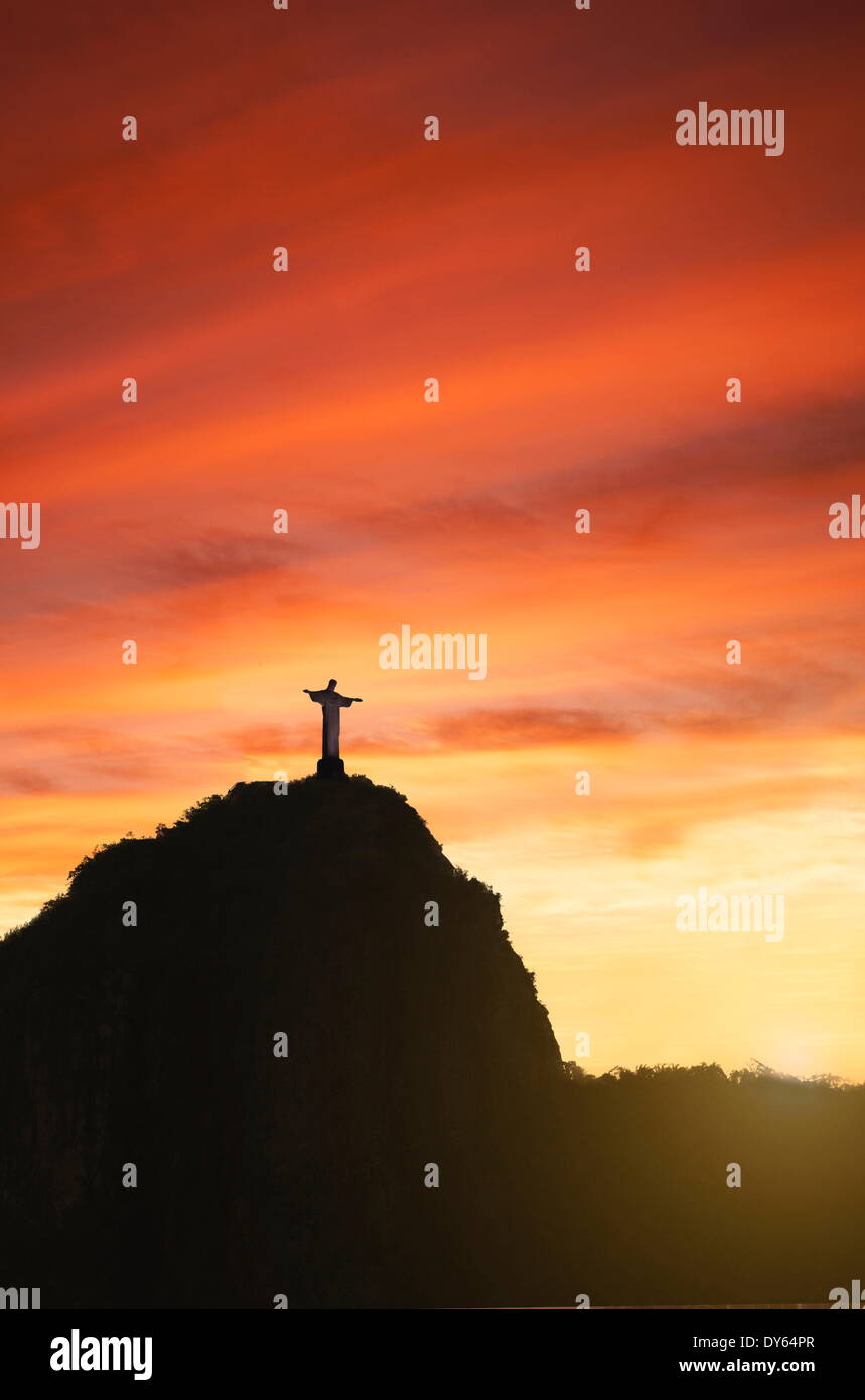 Statue of Christ the Redeemer at sunset, Corcovado, Rio de Janeiro, Brazil, South America Stock Photo