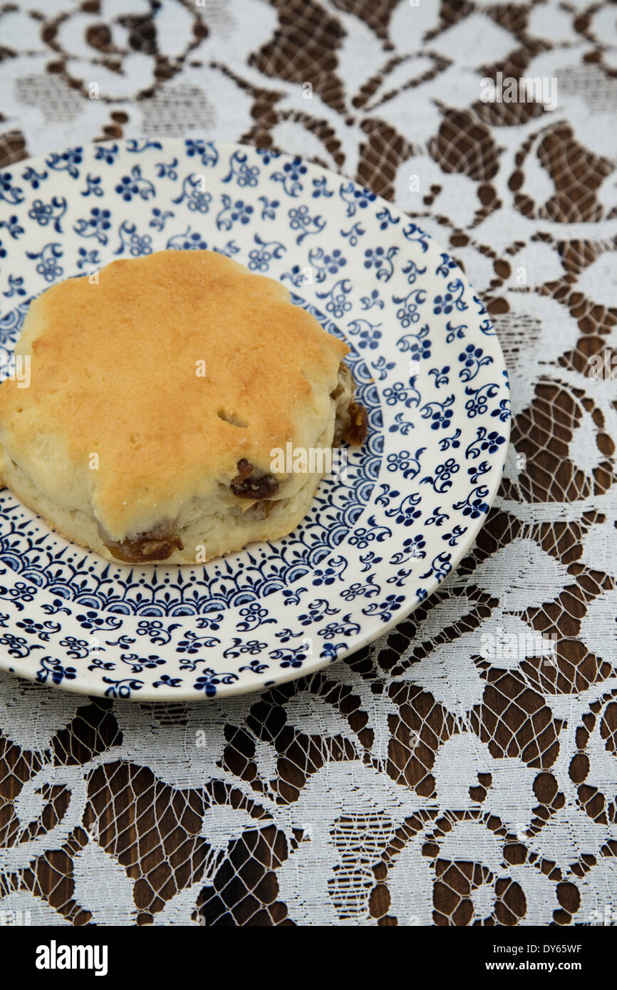 English Afternoon tea. Vintage plate with a Scone on a flora tablecloth Stock Photo