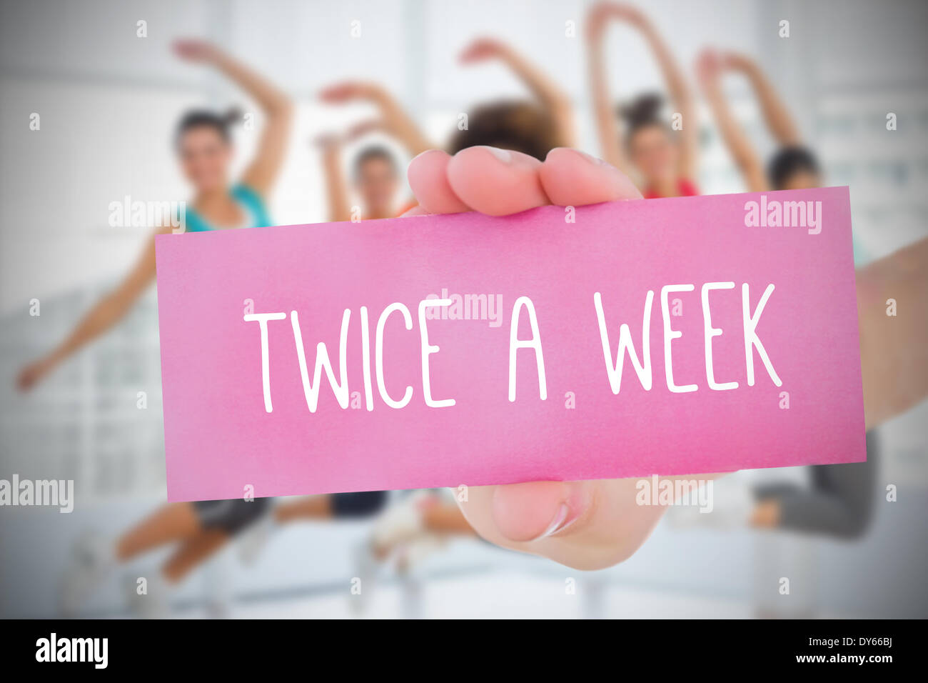Woman holding pink card saying twice a week Stock Photo - Alamy