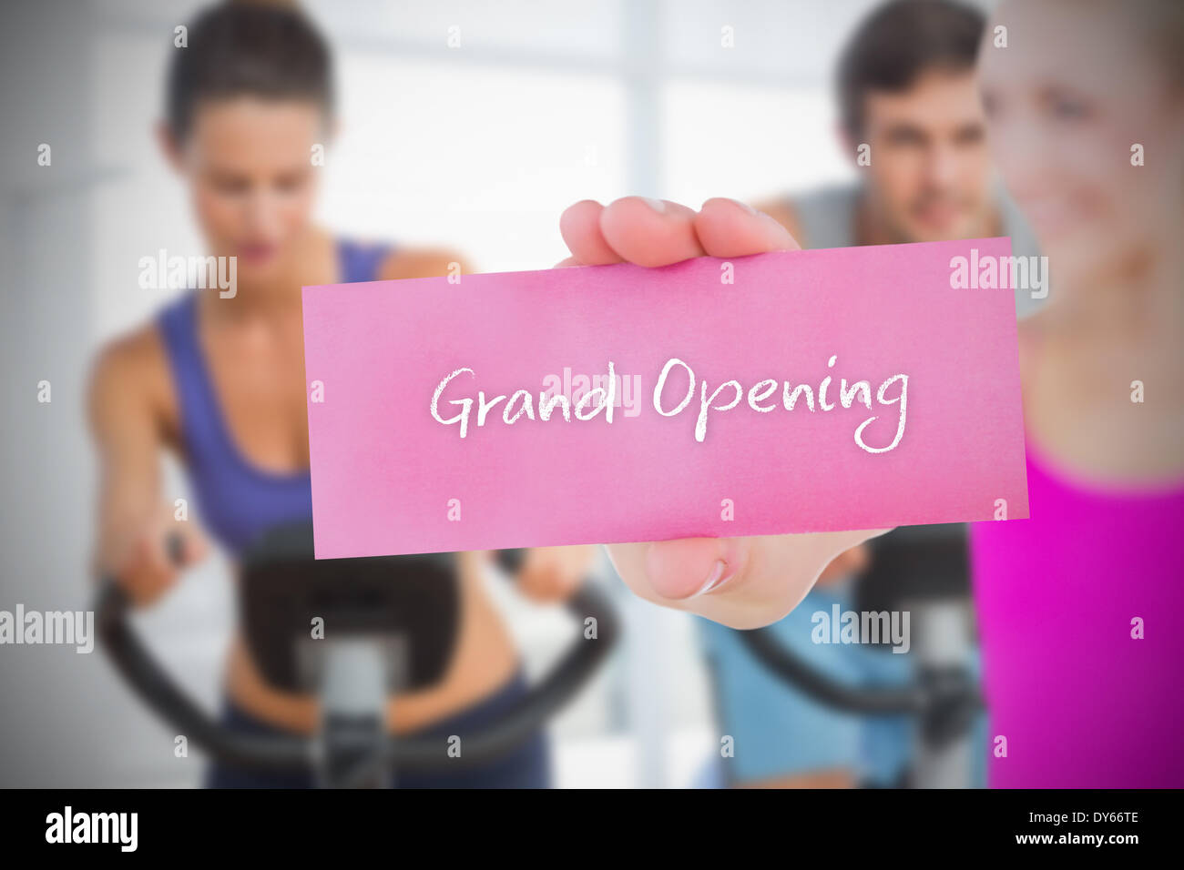 Fit blonde holding card saying grand opening Stock Photo