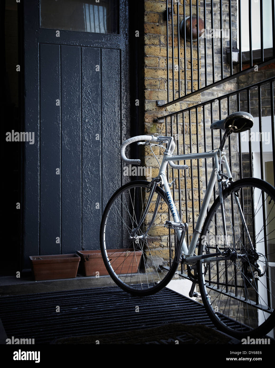 a rod bike chained up outside a studio apartment in London Stock Photo
