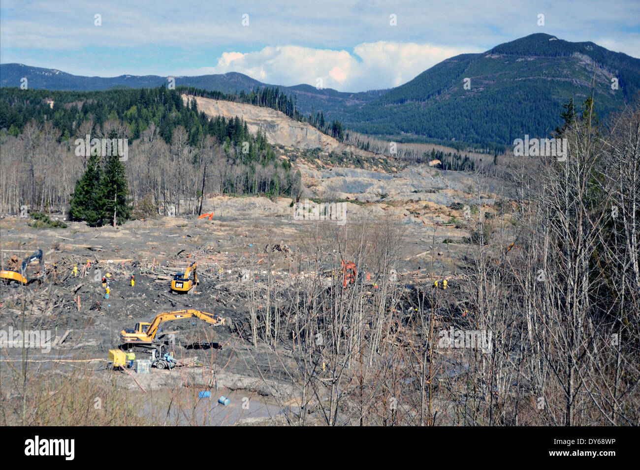 Workers continue search and recovery efforts as the ground slowly dries the landslide zone April 1, 2014 in Oso, Washington. A mudslide buried the tiny village killing at least 30 people. Stock Photo