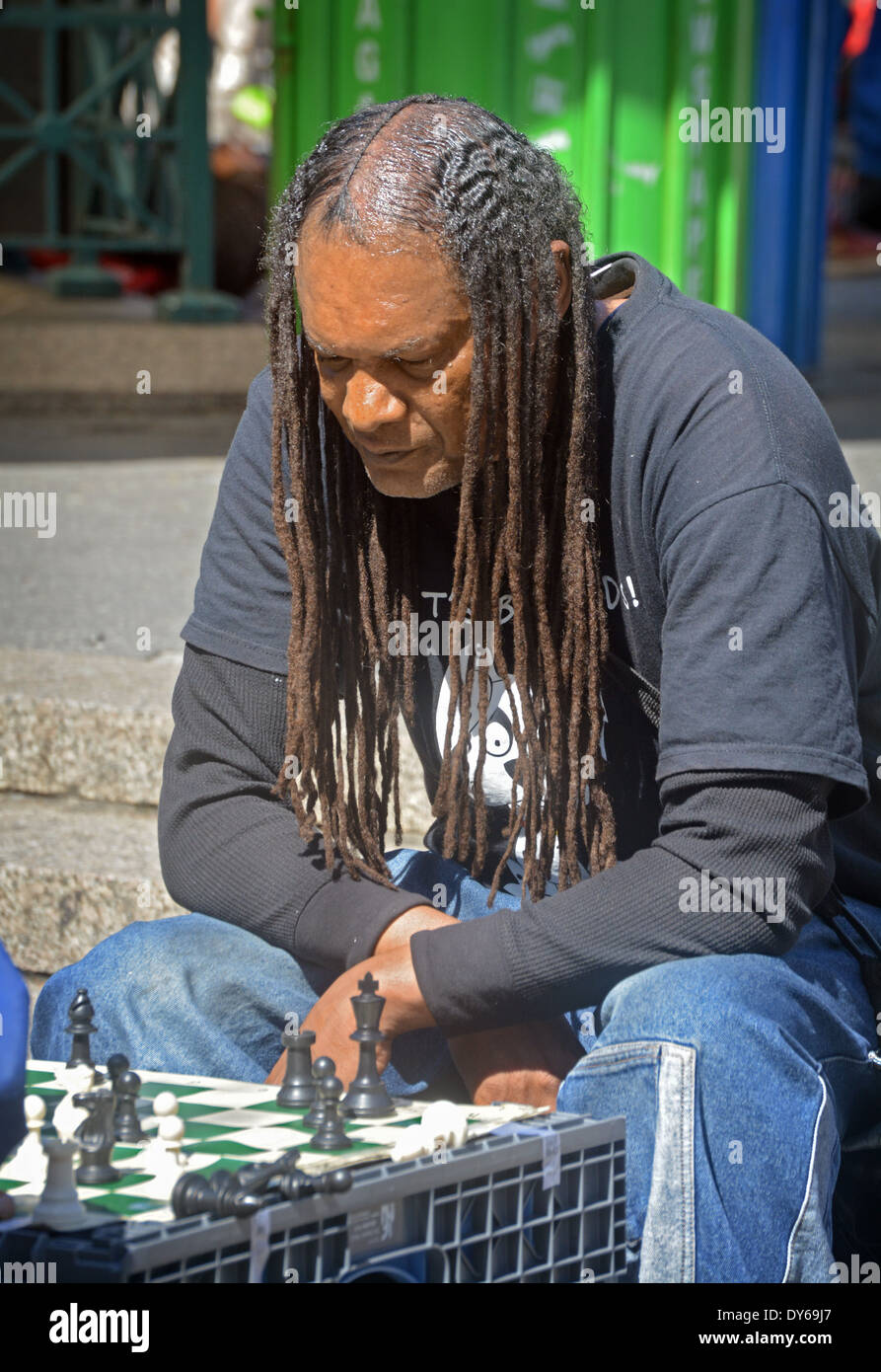 A chess player with long dreadlocks concentrating while playing in Union  Square Park in Manhattan, New York City Stock Photo - Alamy