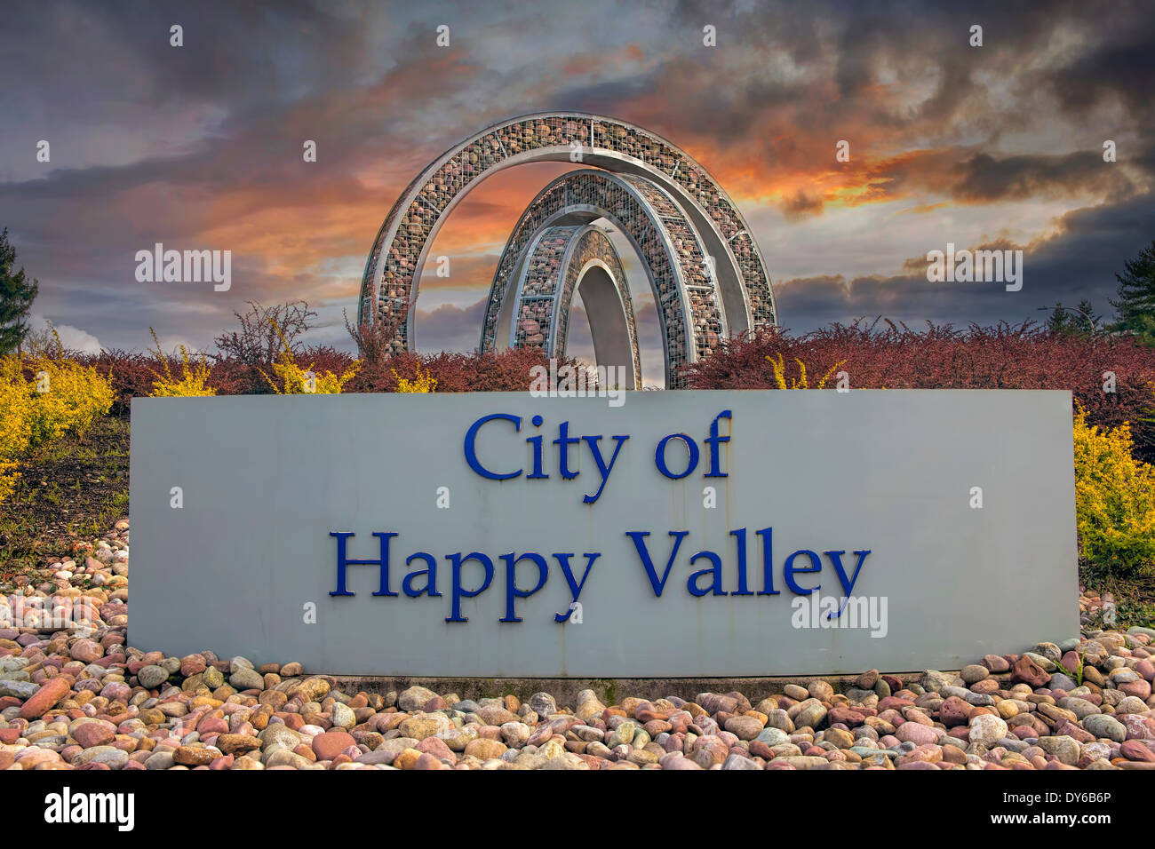 City of Happy Valley in Oregon Entry Sign with Landscaping and Dramatic and Colorful Sunset Stock Photo