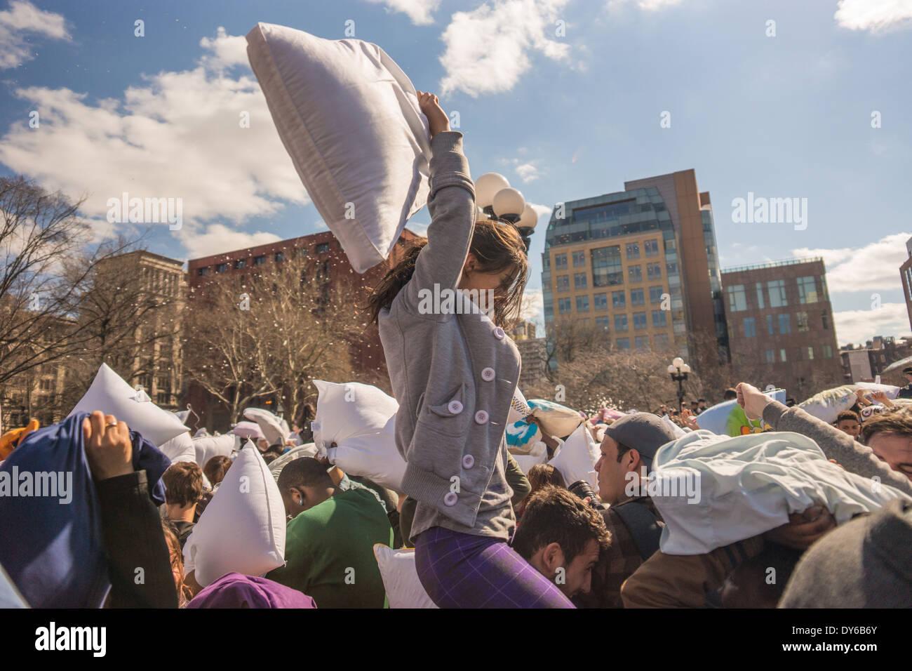 International Pillow Fight Day - Girl Throwing Pillow Stock Photo