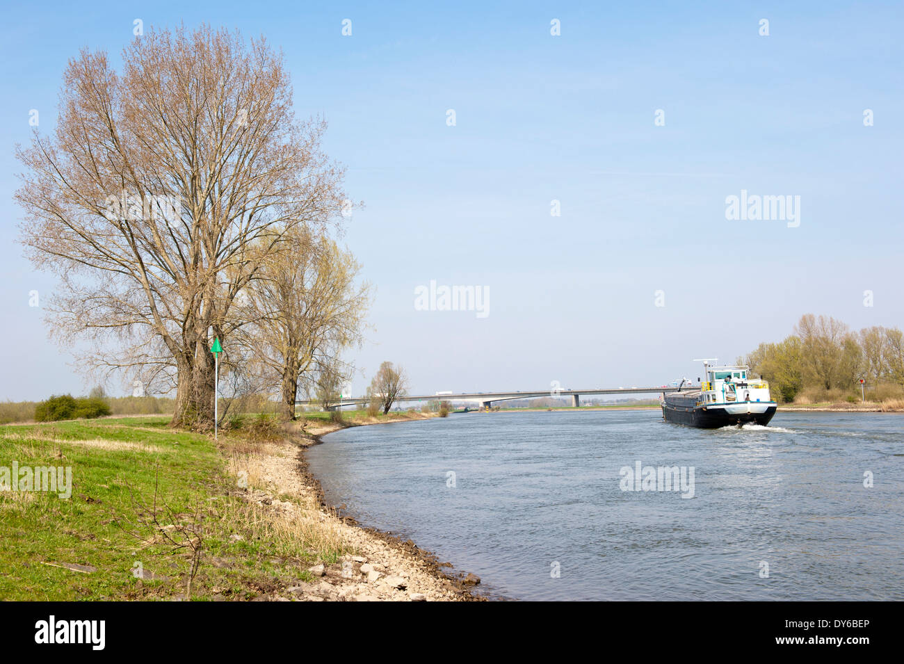 Cargo boat navigating downstream in a rural scenery on the river IJssel on april 13, 2010 at Wilp, the Netherlands Stock Photo