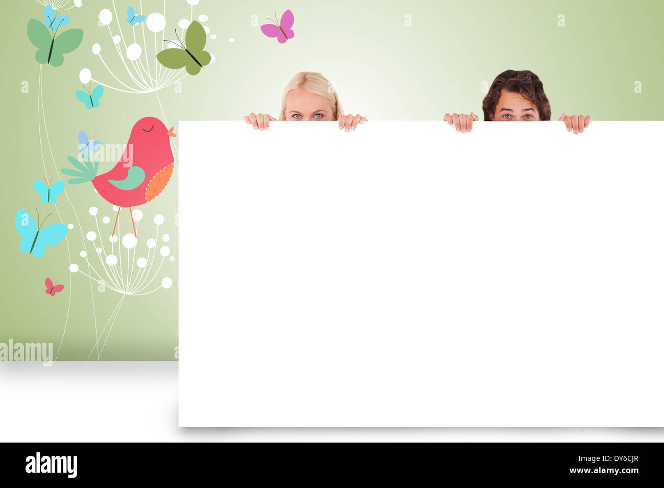 Composite image of attractive couple showing card Stock Photo - Alamy