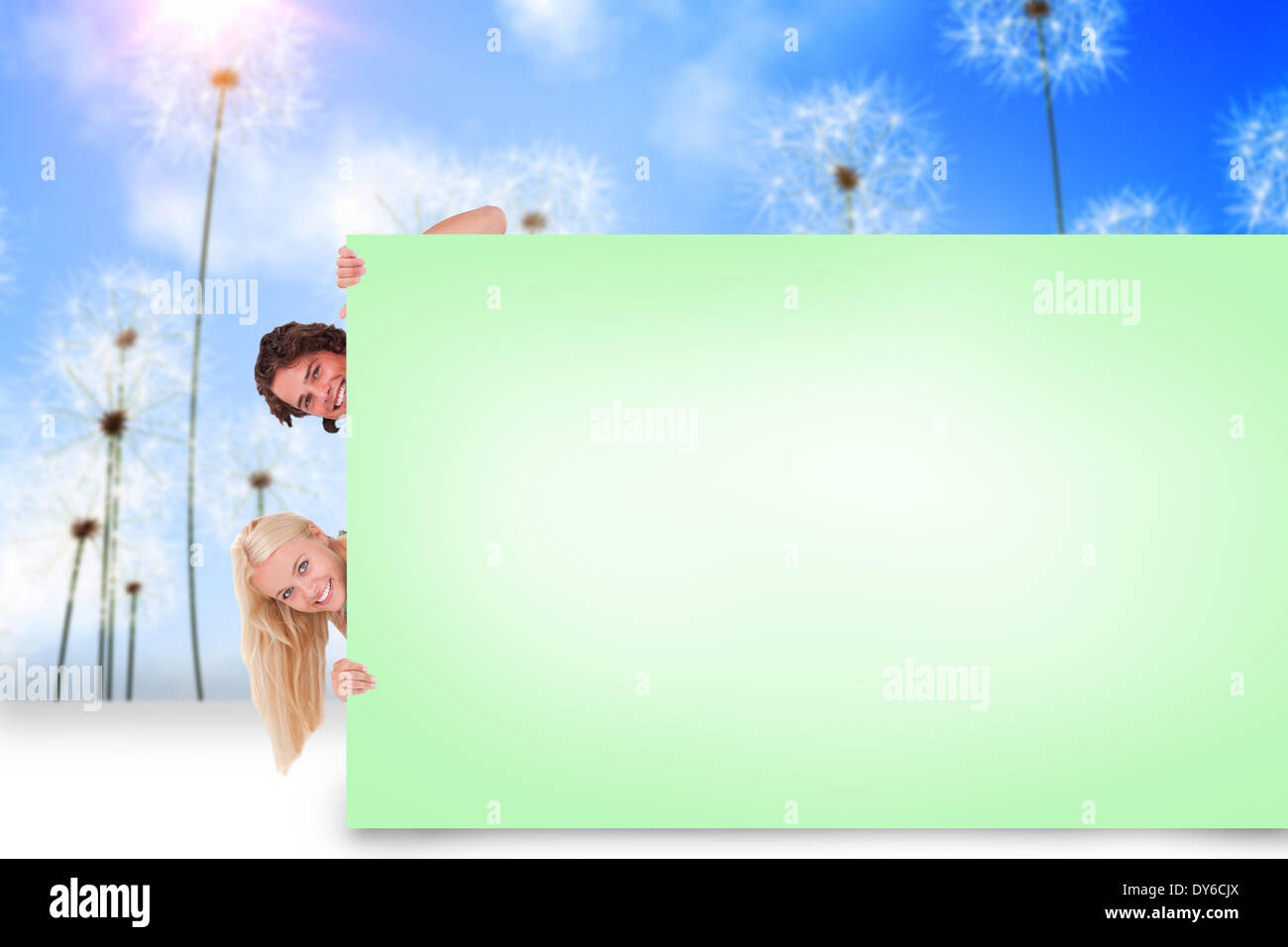 Composite image of attractive couple showing card Stock Photo - Alamy
