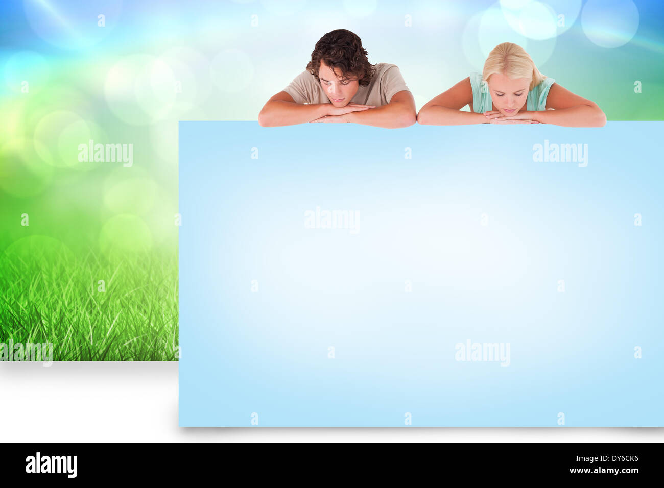 Composite image of attractive couple showing card Stock Photo - Alamy