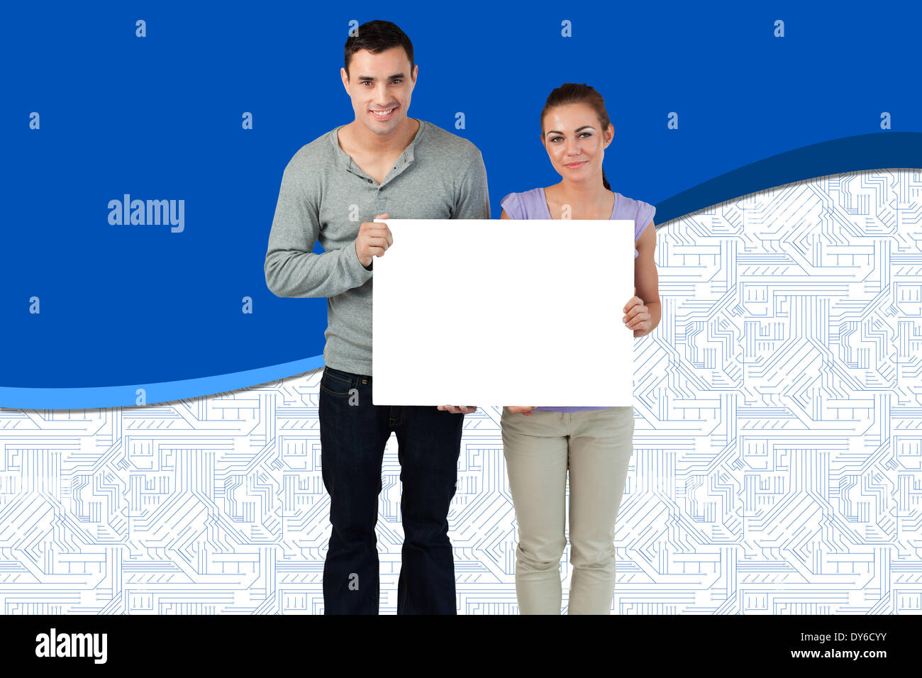 Composite image of attractive young couple showing card Stock Photo - Alamy
