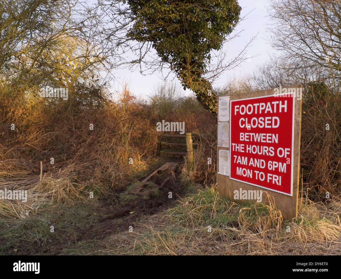Hedgerow with Footpath Closed sign Stock Photo - Alamy