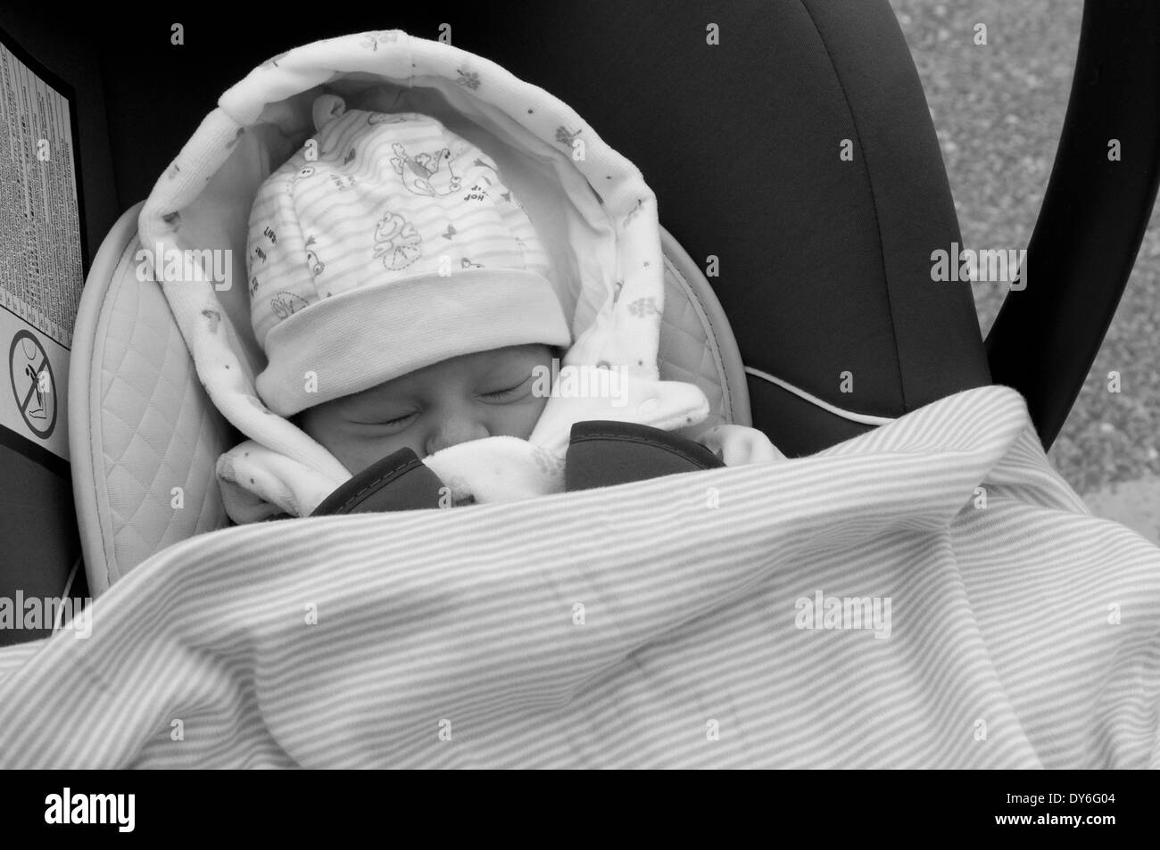 Newborn baby girl, a day old, asleep in car seat, leaving hospital Stock Photo