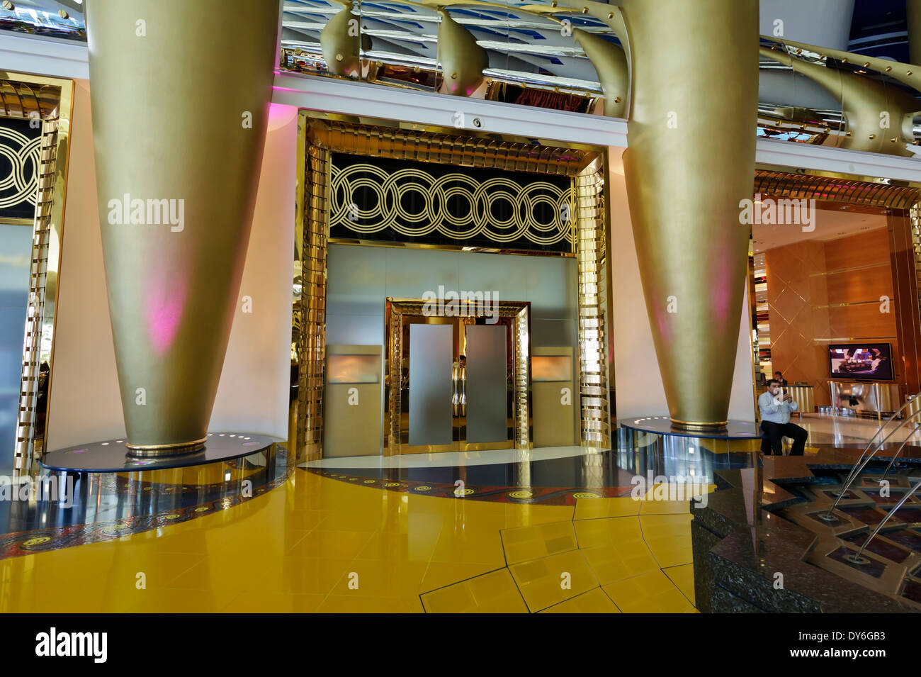 The luxurious interior at the Burj Al Arab Hotel with gigantic pillars and lavish golden decor, Dubai, United Arab Emirates, UAE Stock Photo