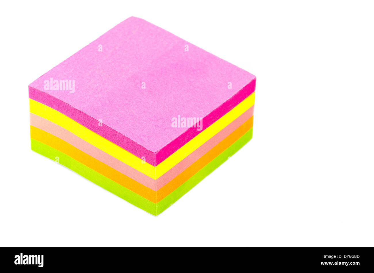 Stack of sticky post-it note pads, some bright, some pastel isolated on white background Stock Photo