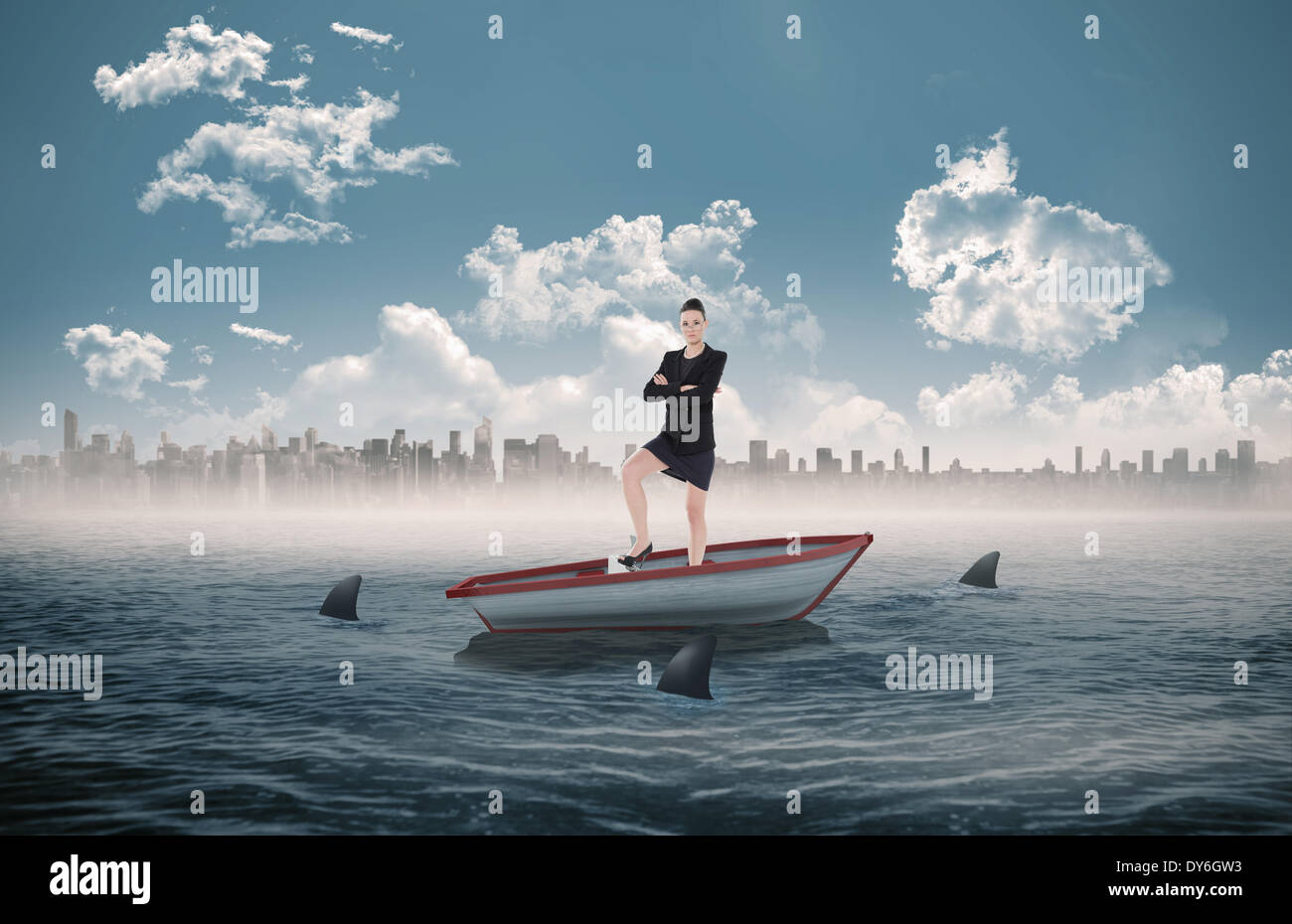 Composite image of full length of an elegant businesswoman in suit in a sailboat Stock Photo