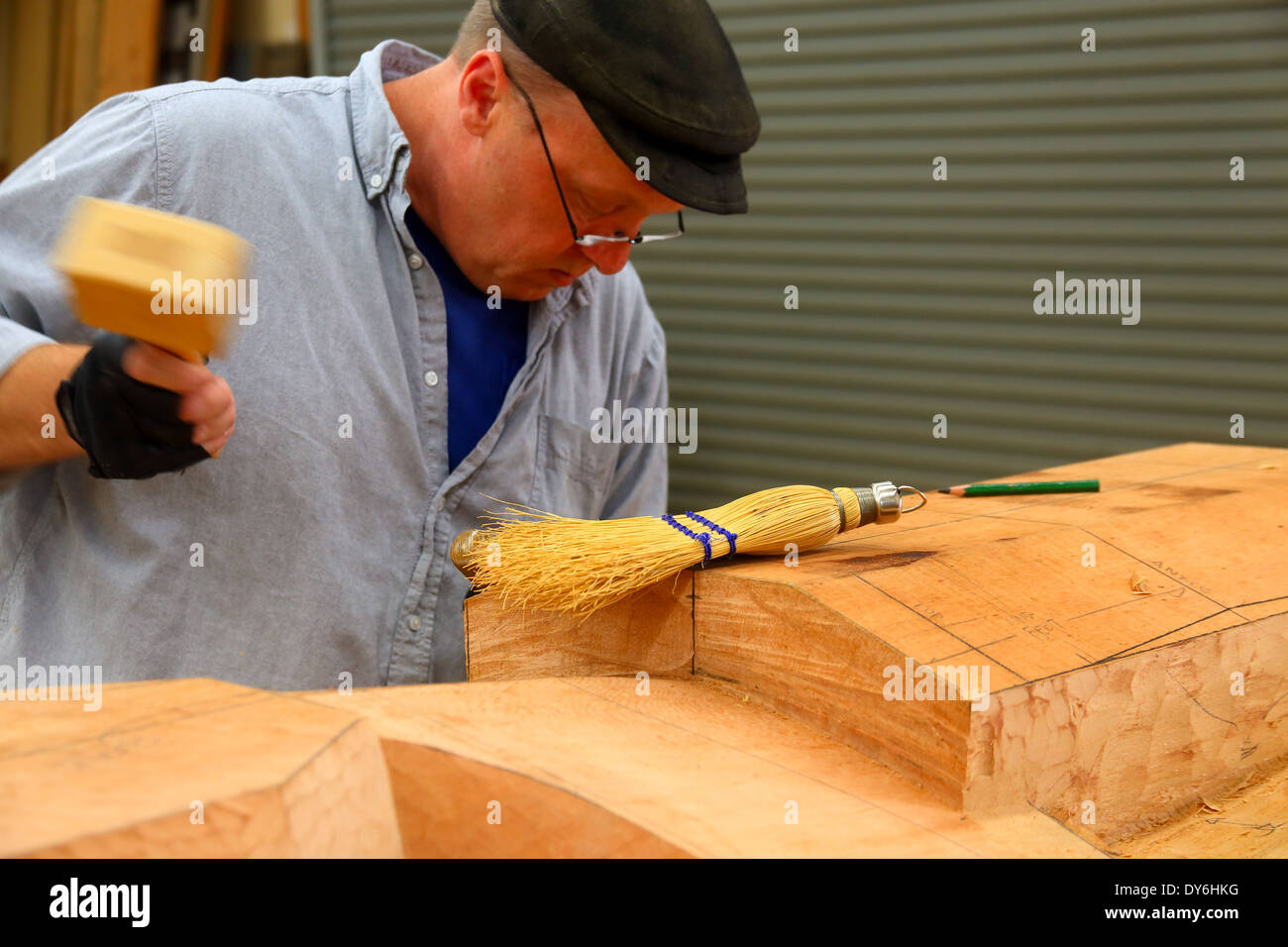 woodcarver is shaping a Indian totem pole Stock Photo