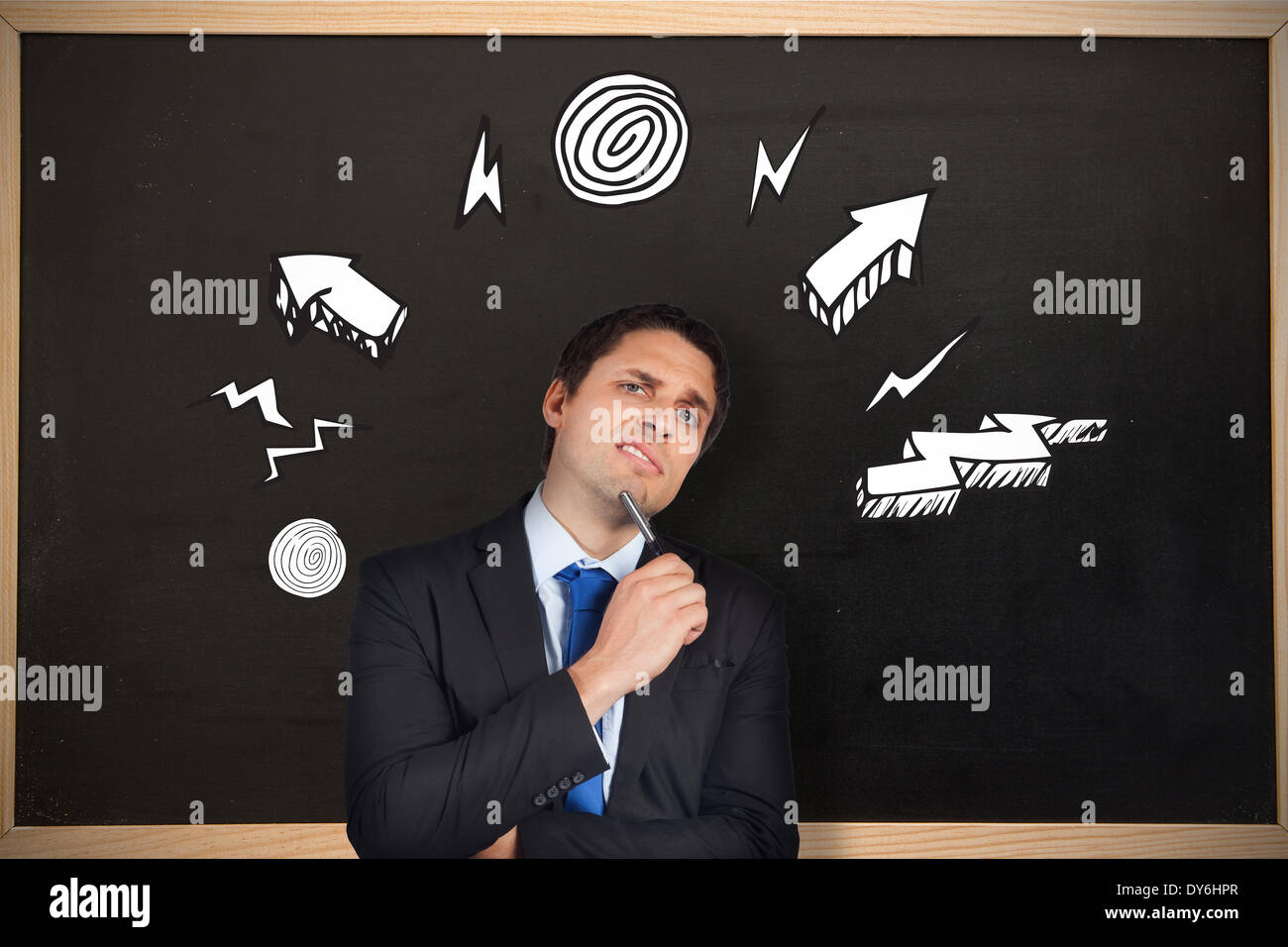 Composite image of thinking businessman holding pen Stock Photo - Alamy