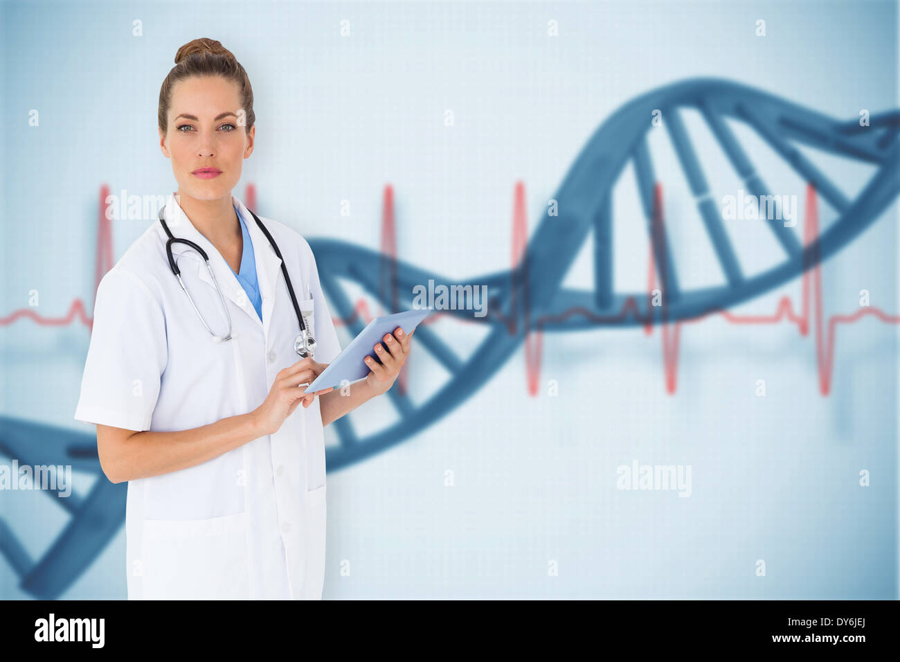 Composite image of pretty nurse using tablet pc Stock Photo