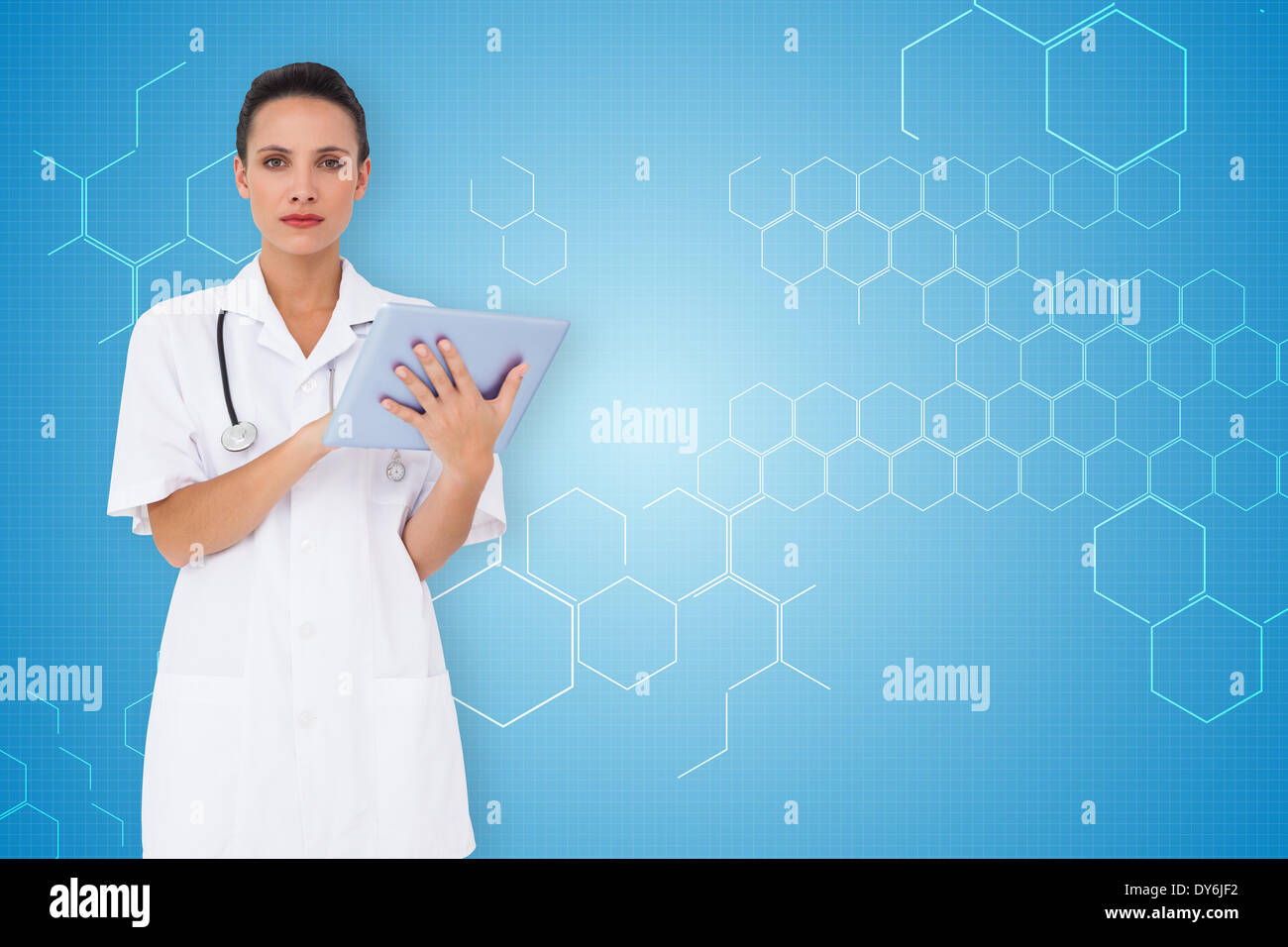 Composite image of pretty nurse using tablet pc Stock Photo