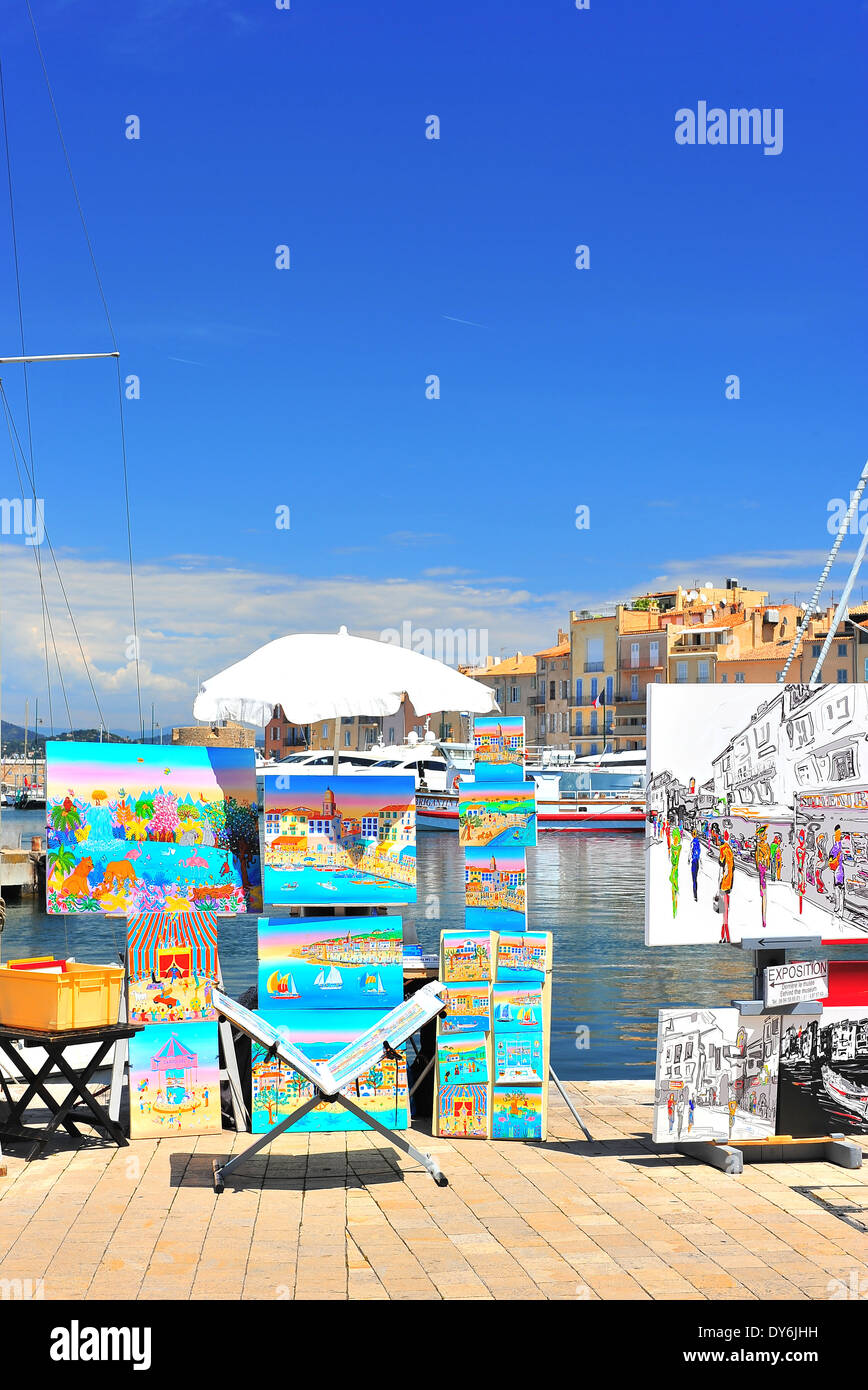 SAINT TROPEZ, FRANCE - MAY 24: View of Saint Tropez harbor with paint art exhibition and sale on May 24, 2012, Saint Tropez. Stock Photo