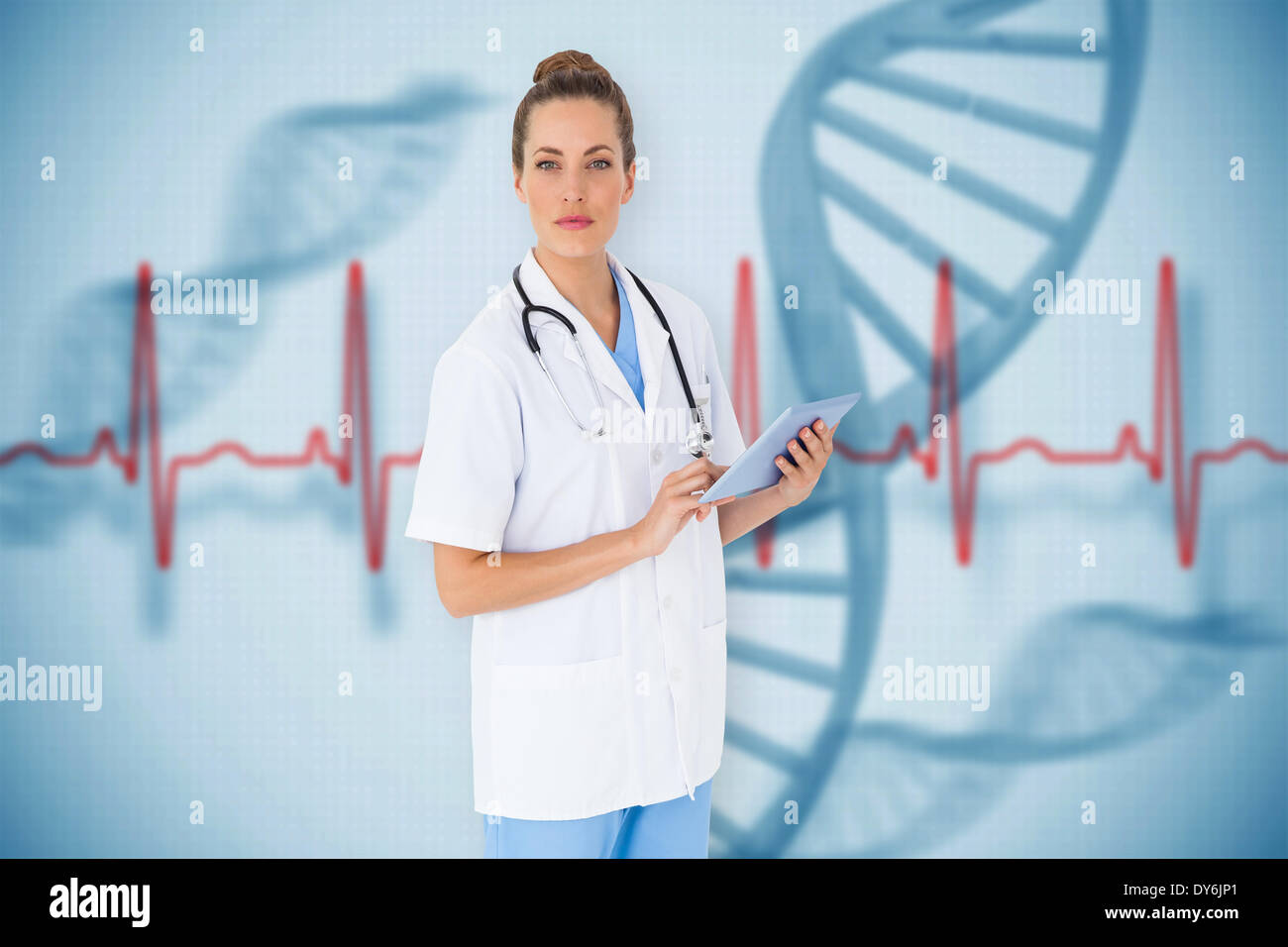 Composite image of pretty nurse using tablet pc Stock Photo