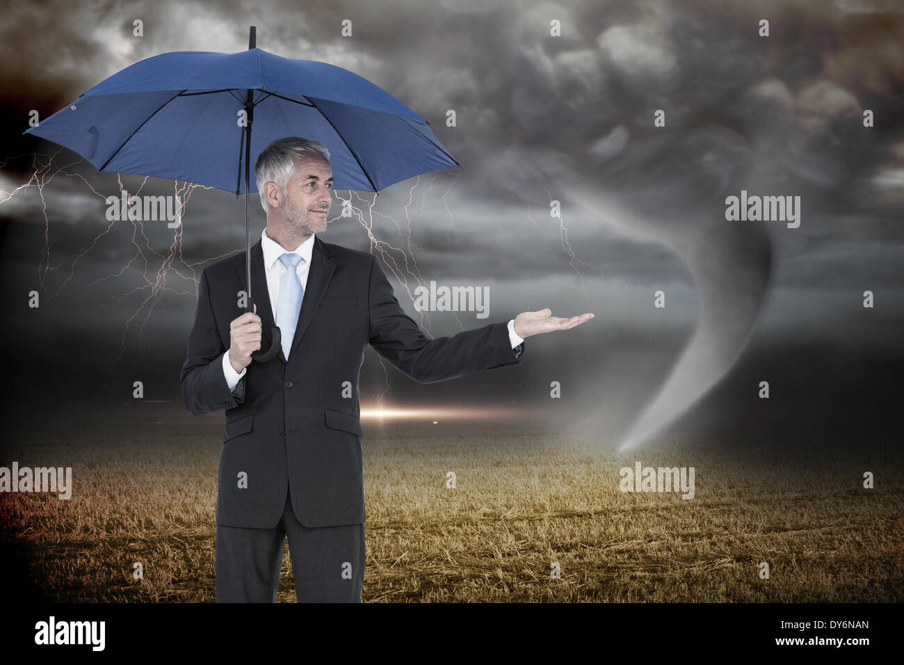Composite image of happy businessman holding umbrella Stock Photo